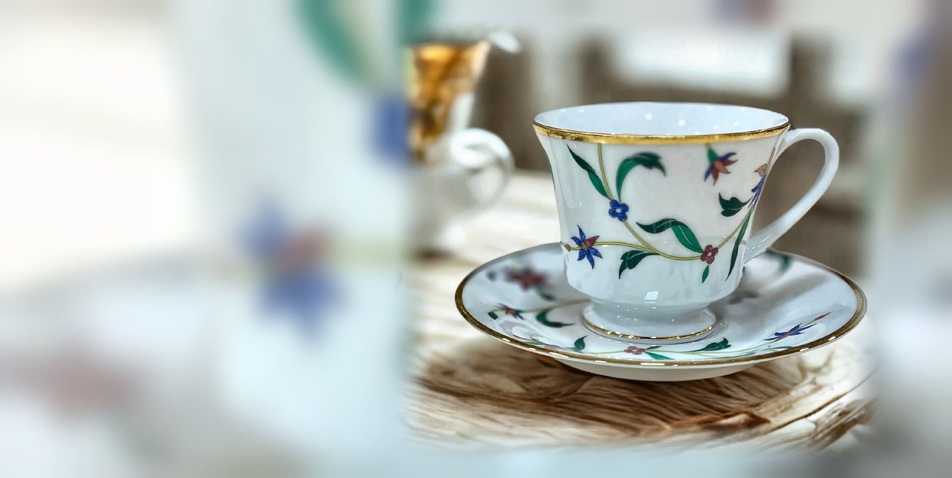 Floral bone china teacup and saucer with a gold rim, ready to gift