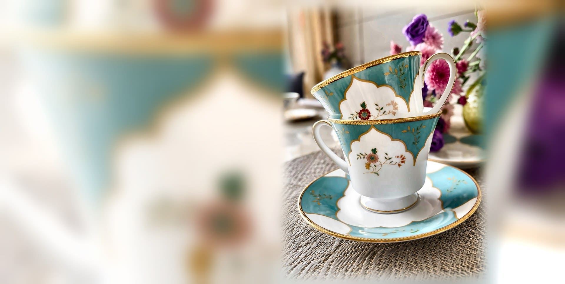 Turquoise and gold bone china cups and saucers arranged as a gift set
