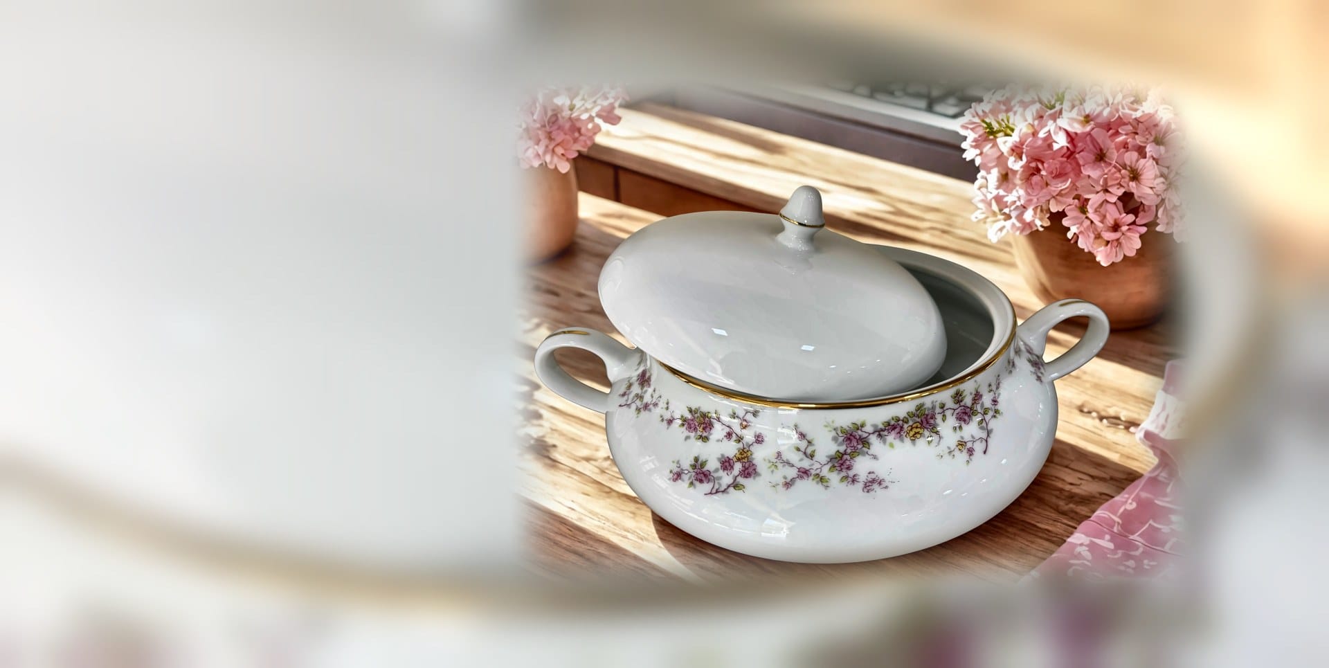 Floral bone china serving tureen with a gold rim, gift-ready on a wooden counter